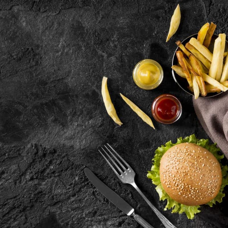 top-view-burger-and-fries-with-sauces-and-copy-space